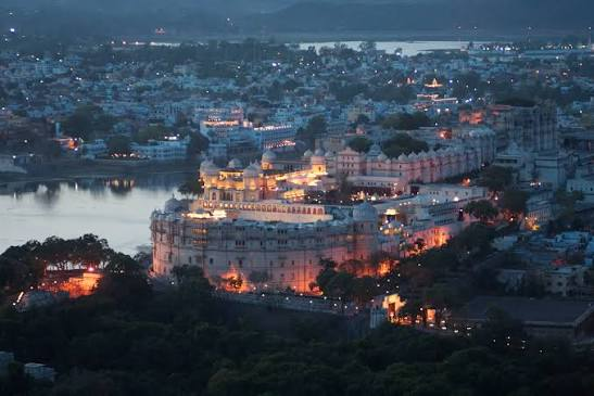 "Best Places to Visit in India – Aerial night view of City Palace overlooking Lake Pichola in Udaipur, Rajasthan."